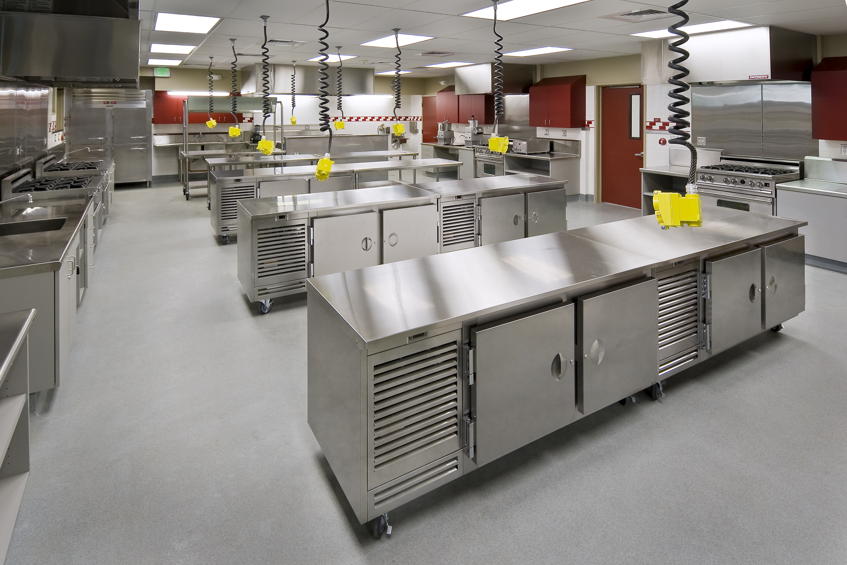 What are the demands on commercial kitchen floors?